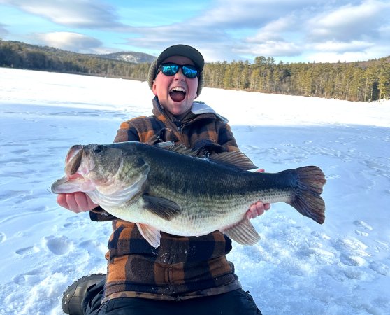 A Massachusetts teenager holds up a state-record bass.